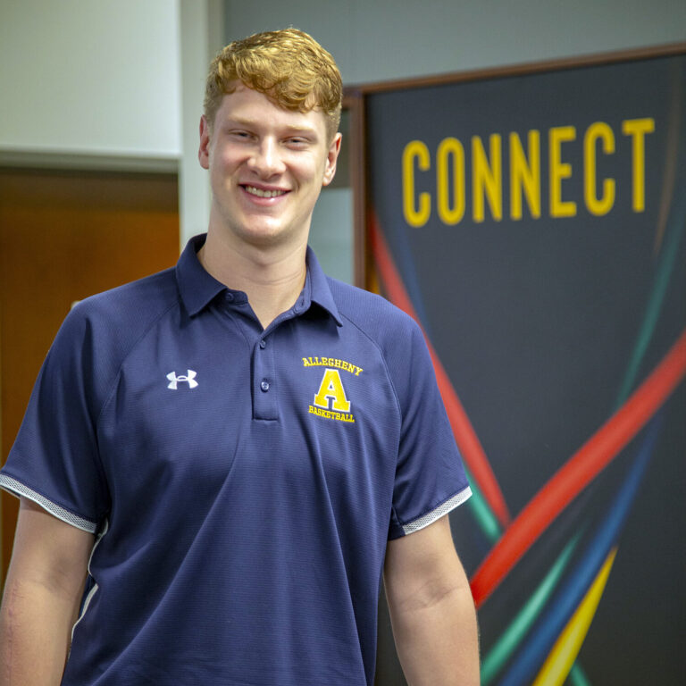 a smiling man in a blue shirt