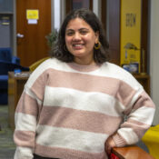 a smiling woman in a striped sweater