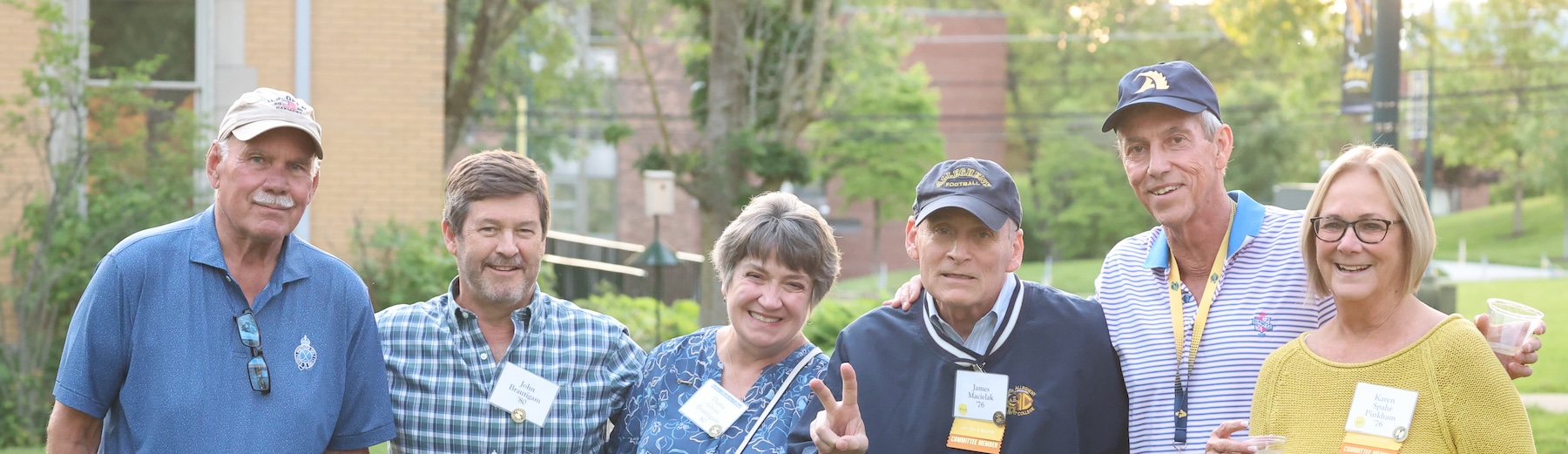 A group of Allegheny College alumni stand and smile