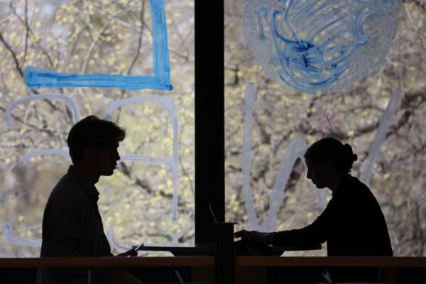 silhouette of people sitting at a desk