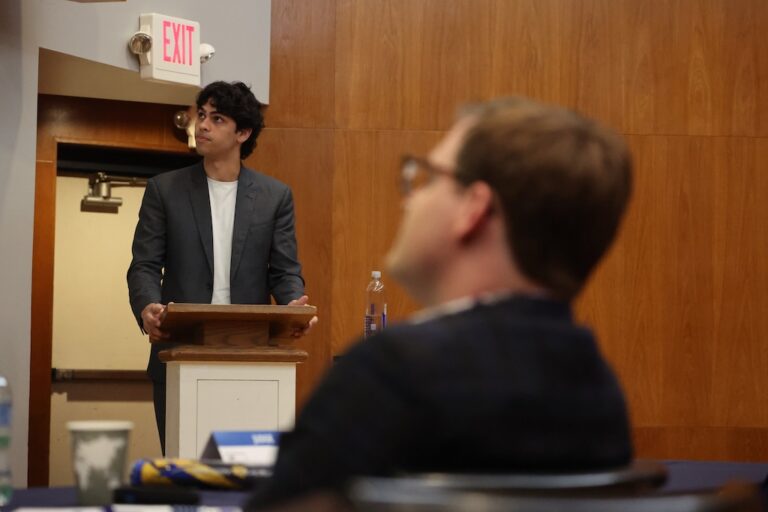 Student presents at a podium during the premilinary round of Allegheny College's 2026 Zingale Bid Idea Competition