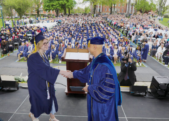 Student receiving a diploma at the 2026 Commencement