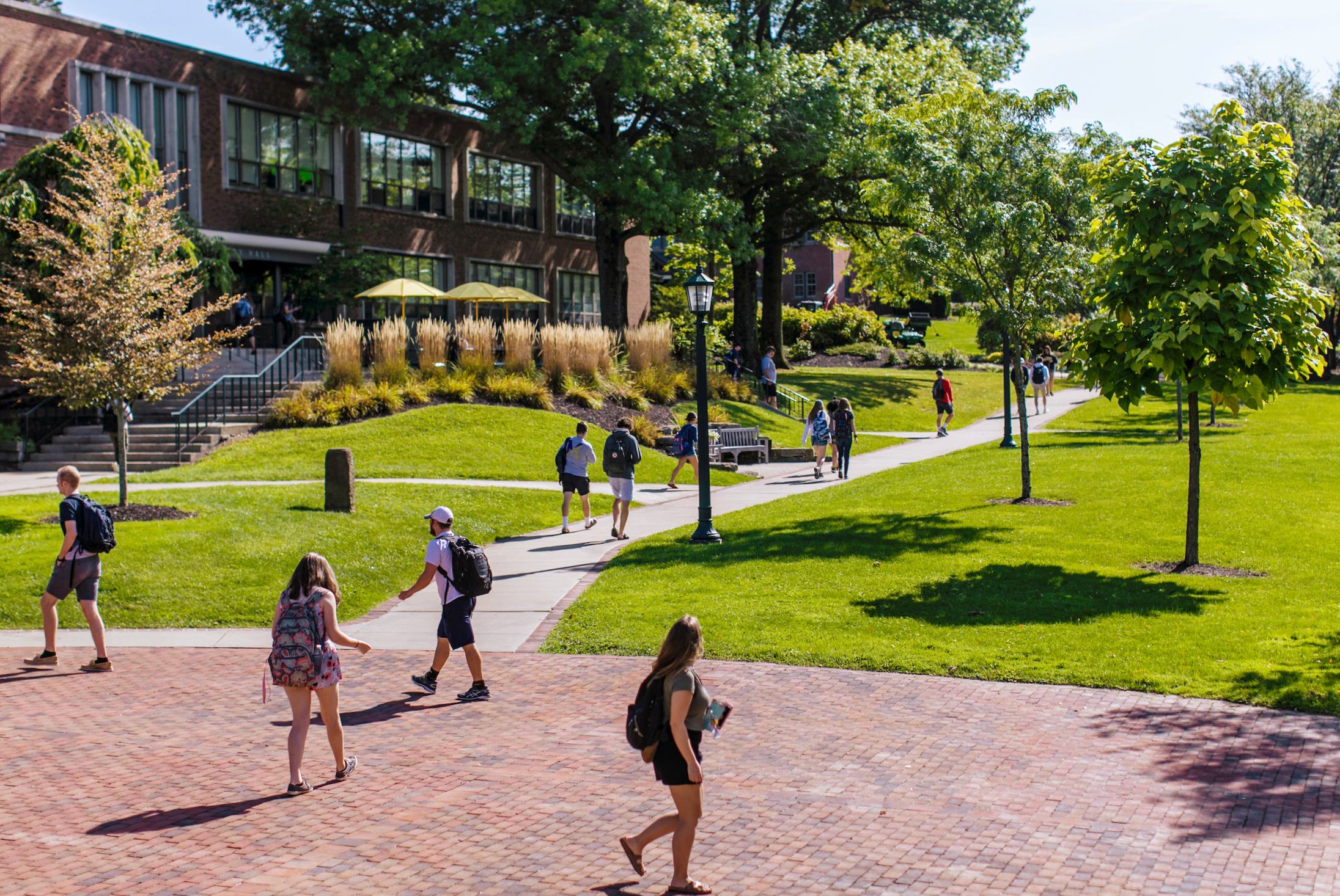 Students walking outside Quigley Hall in the early fall
