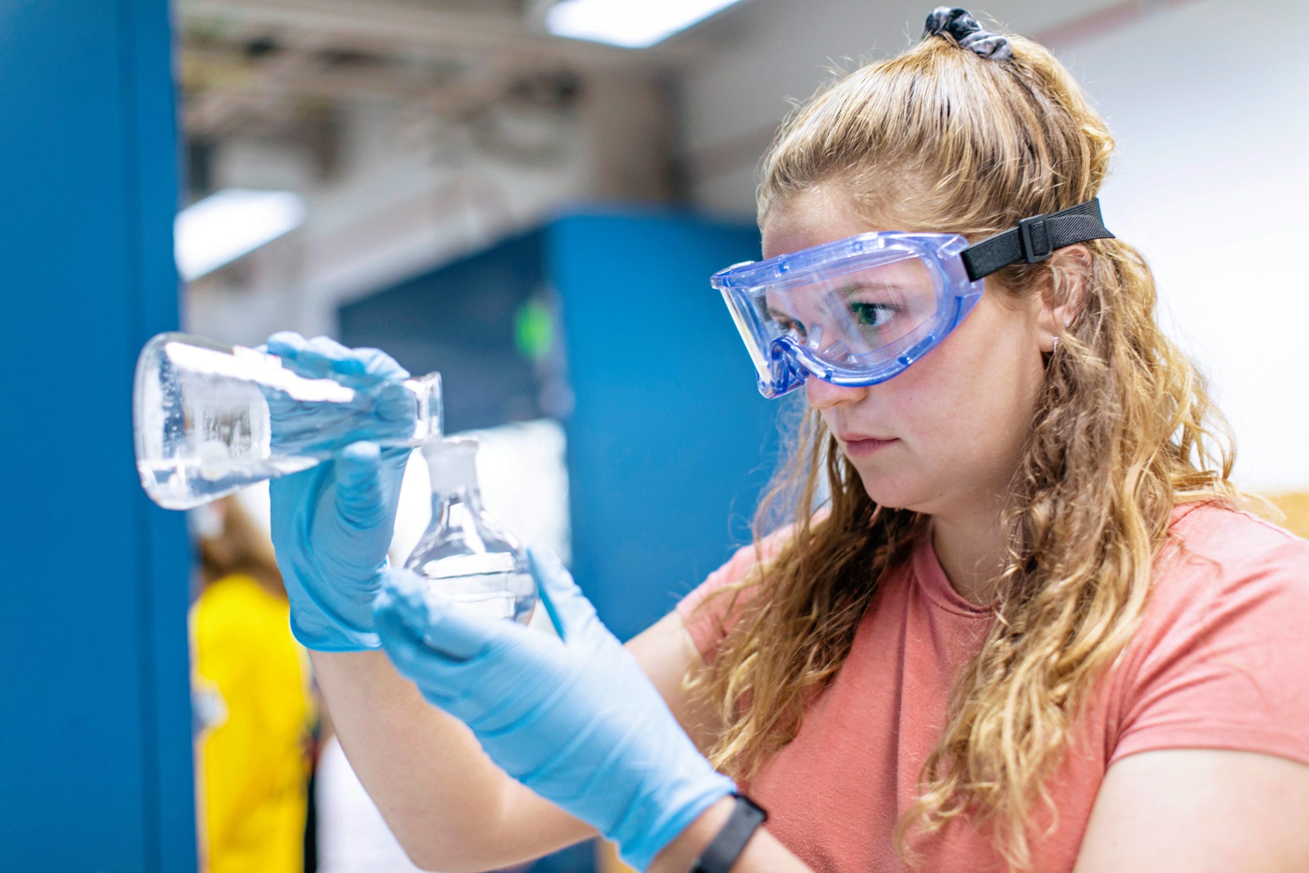 Student observing a chemistry beaker