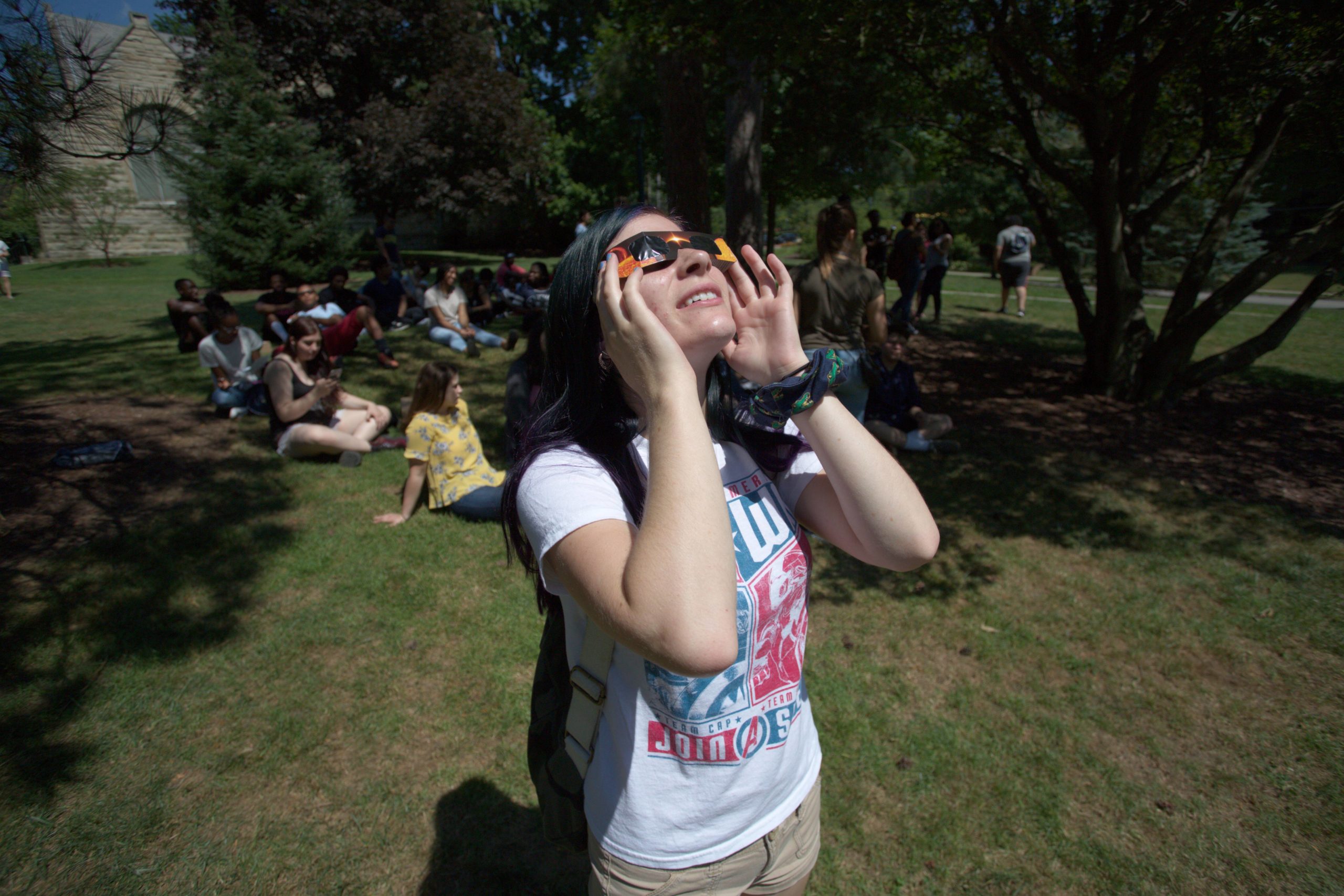 Student watches eclipse through protective glasses
