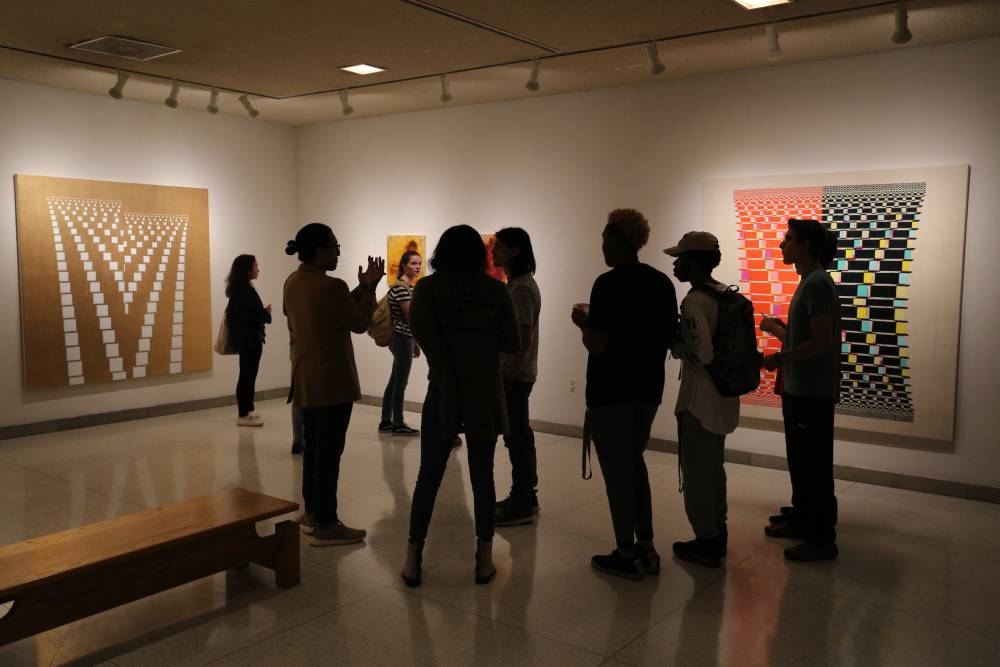 Students looking at art in an art gallery