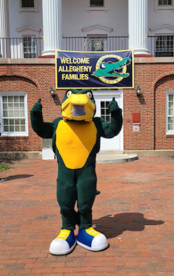 a person in an alligator mascot costume