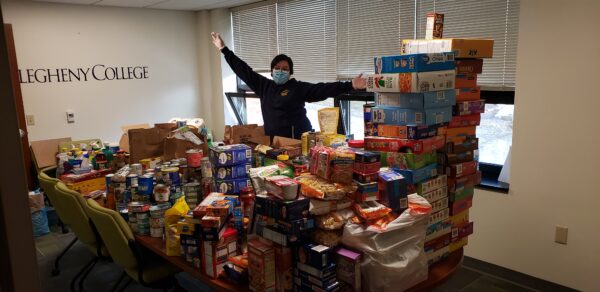 a person standing in front of a pile of boxes