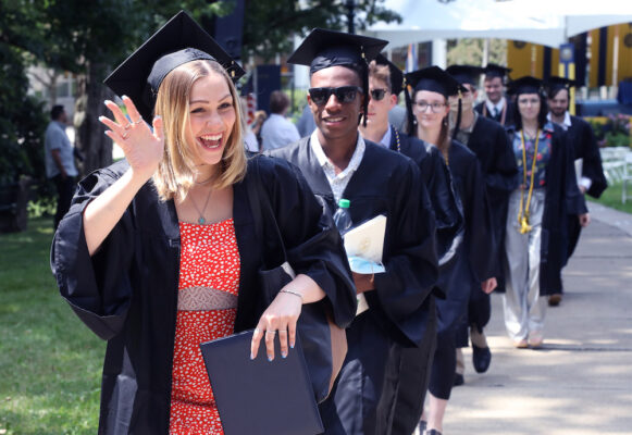 a group of people in graduation gowns and caps
