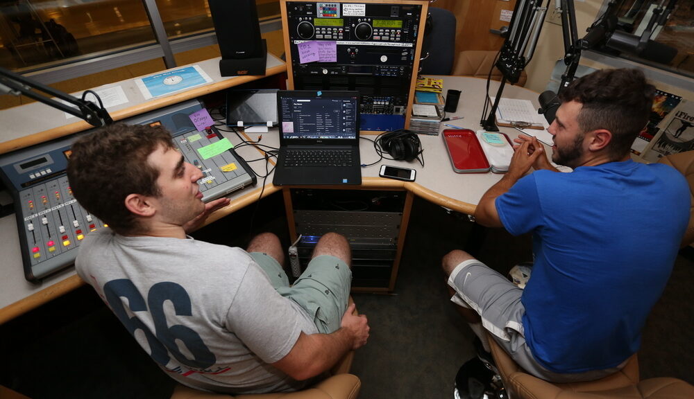 male student, radio, WARC, sitting, talkingStudents in the WARC radio station