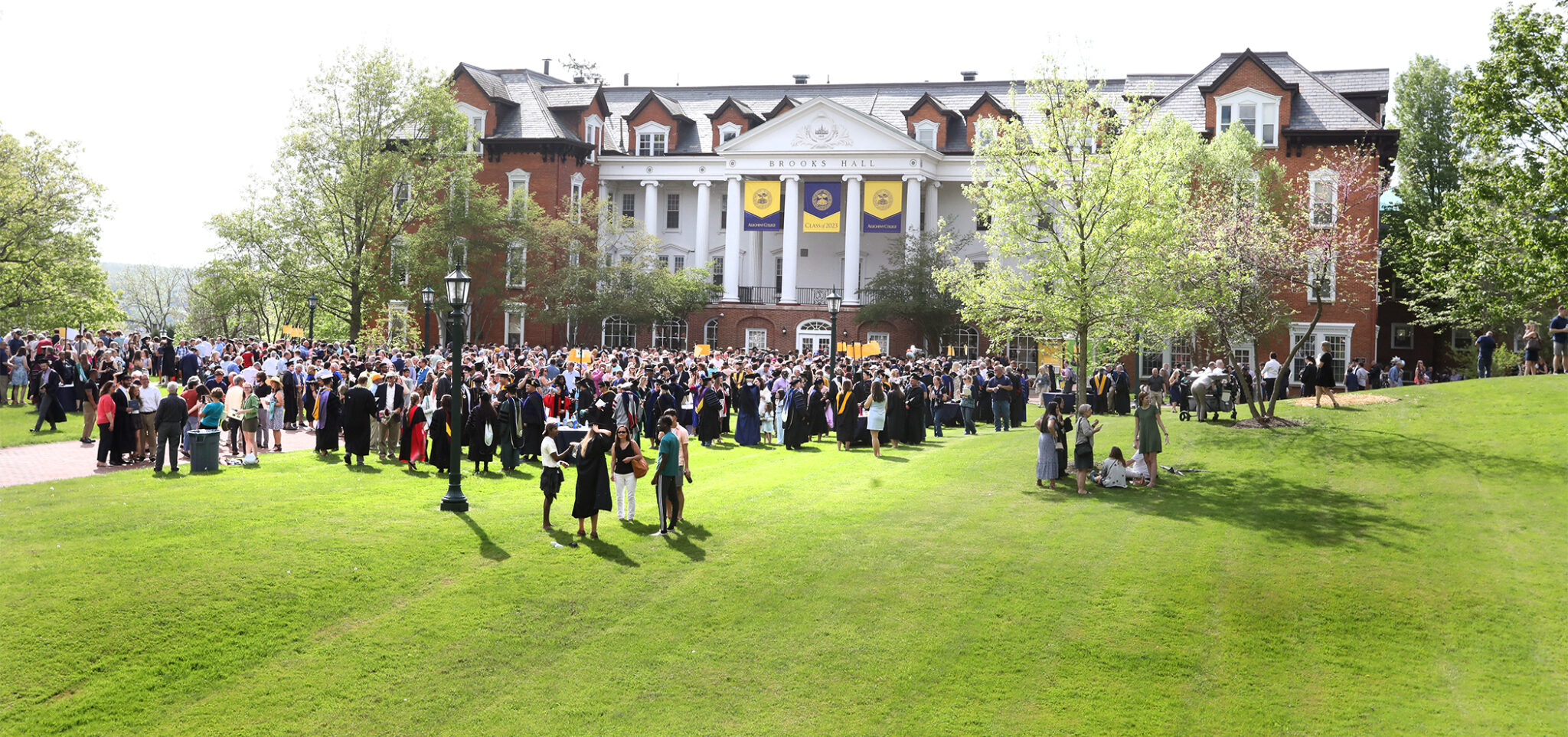 crowd of people gathered in front of Brooks Hall after commencement