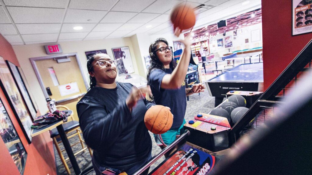 Students playing in the game room