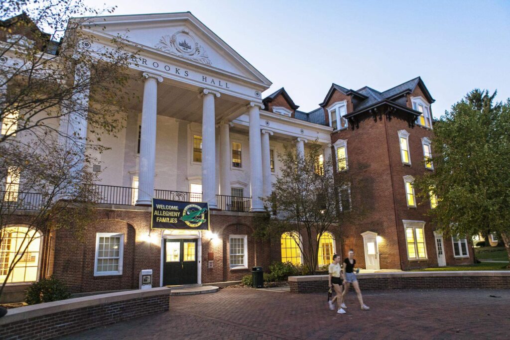 students walking in front of campus building