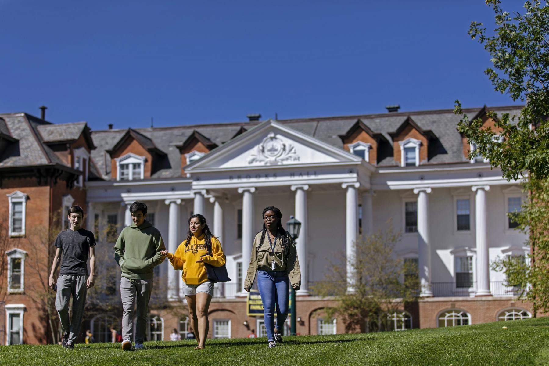 Four students walking on campus