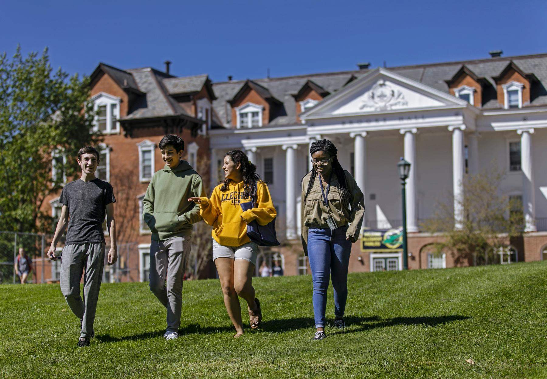 Four students walking on campus