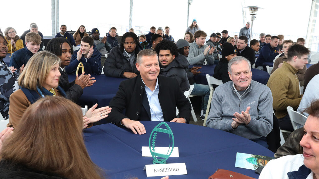 Allegheny College community sitting at tables clapping
