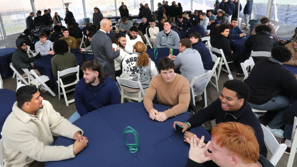Allegheny College community sitting at tables talking