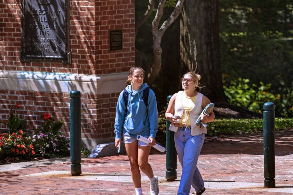 Two students walking on Brooks Walk