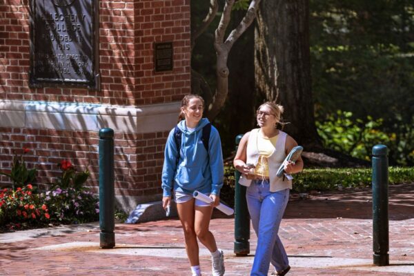 Two students walking on Brooks Walk