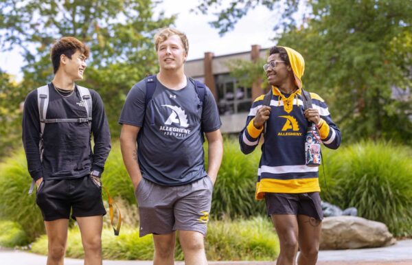 a group of students walking on a sidewalk