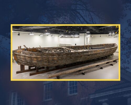 A wooden boat on display in an exhibit