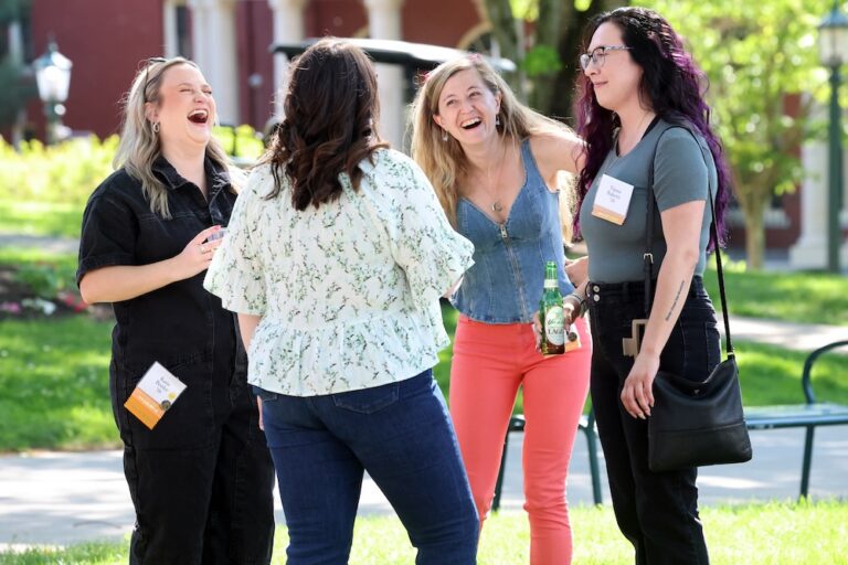 A group of Allegheny College alumni talk and laugh during a Reunion Weekend