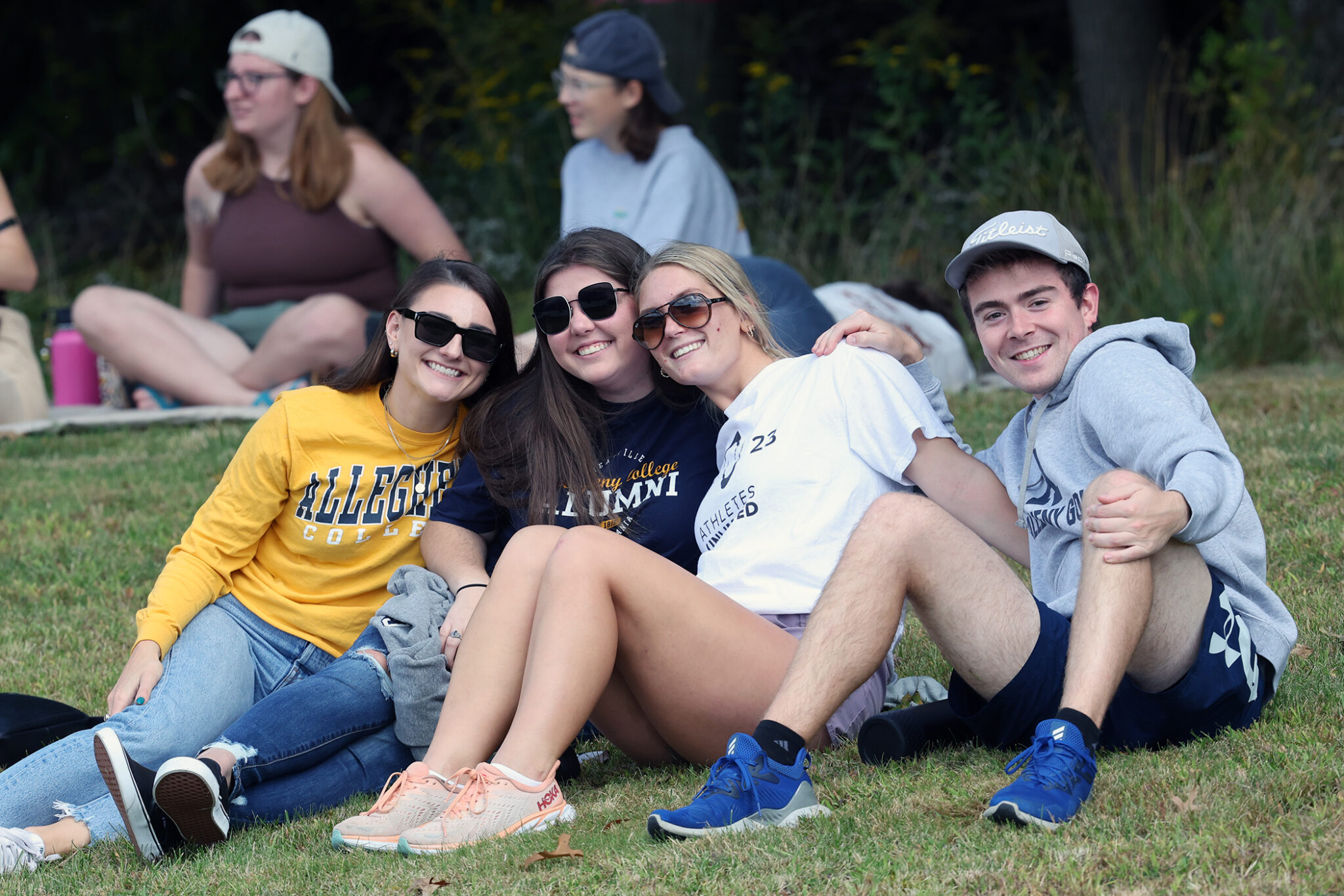 Four alumni smiling