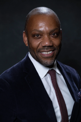 portrait of a person in a suit smiling
