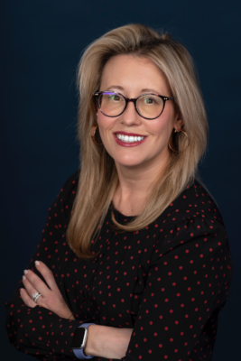 portrait of a person wearing glasses and smiling