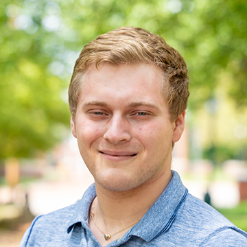 a person smiling in a blue shirt