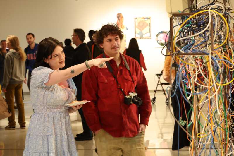 People standing around at an art show.