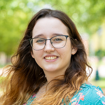 a person with long hair wearing glasses