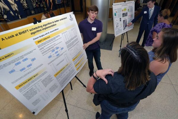 student presenting research to peers