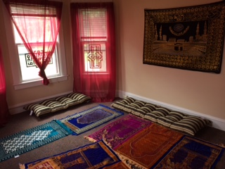 a room with colorful rugs and pillows