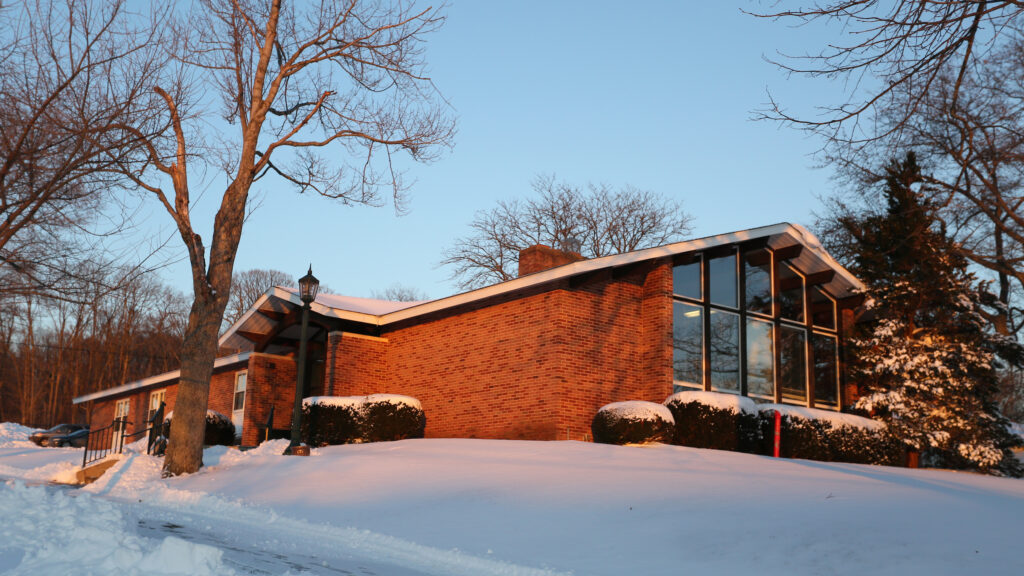 a red brick building with snow on the ground