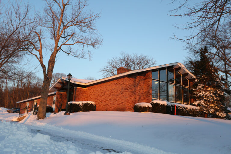 a red brick building with snow on the ground