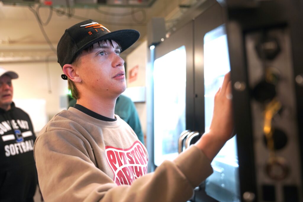 Student working a machine