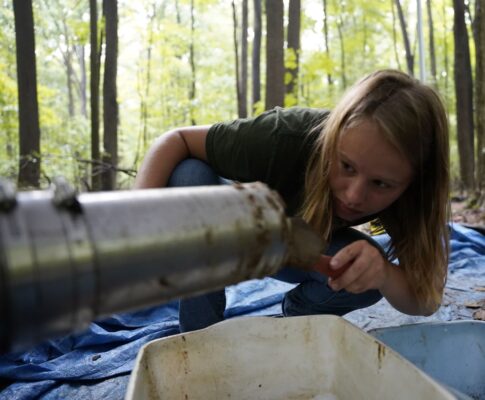 a person pouring water into a container