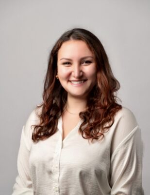 a person with long brown hair smiling