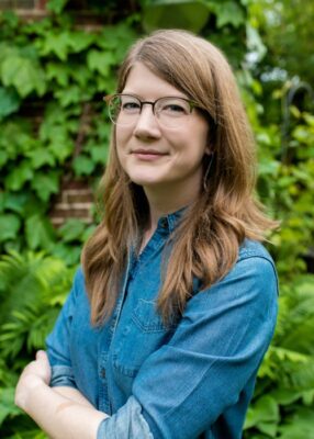 portrait of a person with long hair wearing glasses