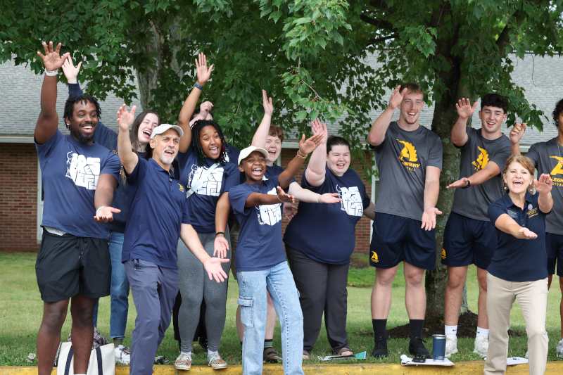 A group of students outside cheering.