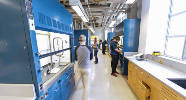 a group of people in a laboratory with blue walls