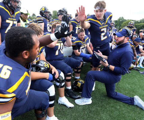 Allegheny's Football team high-fiving.