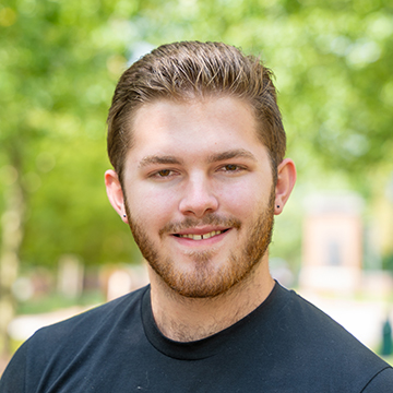 a person with a beard smiling