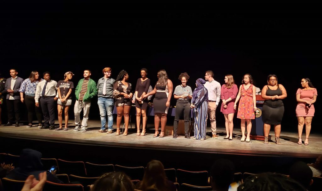 a group of students standing in a line on a stage