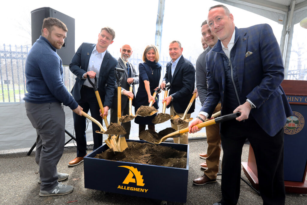 People shoveling dirt for a groundbreaking