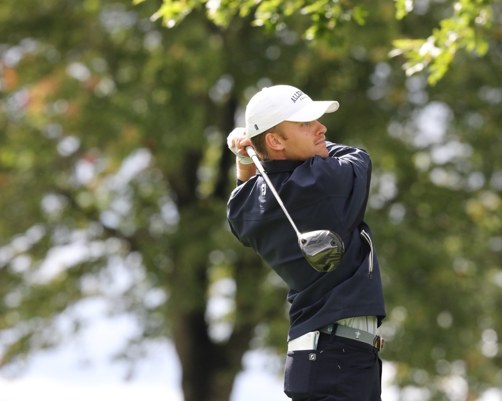 Allegheny Gators Head Golf Coach Carter Hassenplug '25 swings a golf club