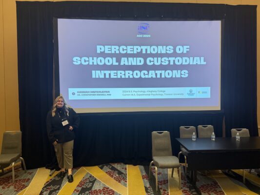 Student standing in front of presentation screen
