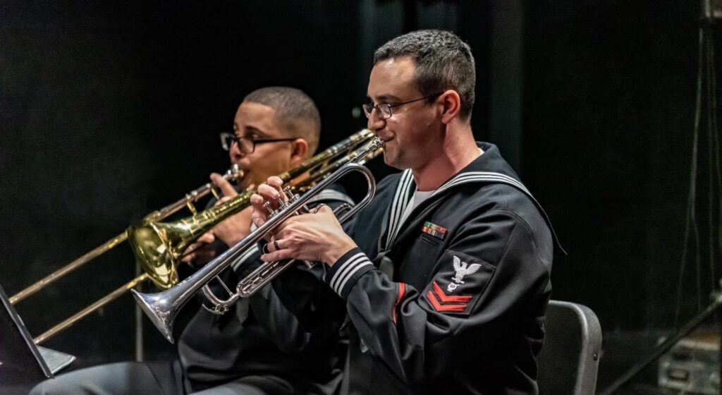 a person playing a trumpet in military dress