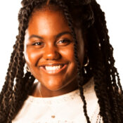 Smiling woman with long black hair and white shirt